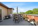 An outdoor deck with dining furniture, an umbrella, and lots of potted plants at 64 Emerson Hill Sq, Marietta, GA 30060
