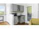 This wet bar features gray cabinets, granite countertop, and a microwave at 64 Emerson Hill Sq, Marietta, GA 30060