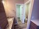 Bright bathroom with marble counter tops, neutral walls, and wood look floors at 11447 Vinea Ln, Hampton, GA 30228