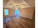 Spacious bedroom with hardwood floors, recessed lighting, and natural light from multiple windows at 11447 Vinea Ln, Hampton, GA 30228