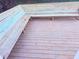 Corner view of the wooden deck featuring built-in seating at 11447 Vinea Ln, Hampton, GA 30228