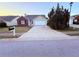 Attractive single-story home with a brick detail, an attached garage, and a long concrete driveway at 11447 Vinea Ln, Hampton, GA 30228