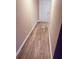 Hallway with white baseboards and wood look floors at 11447 Vinea Ln, Hampton, GA 30228