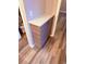 Hallway with hardwood floors and cabinets, offering ample storage space at 11447 Vinea Ln, Hampton, GA 30228
