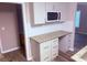 Charming kitchen featuring granite countertops, wood cabinets, and stainless steel microwave at 11447 Vinea Ln, Hampton, GA 30228
