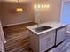 Kitchen island with granite counters and a stainless steel sink, perfect for food preparation at 11447 Vinea Ln, Hampton, GA 30228