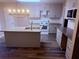 Well-lit kitchen featuring granite countertops, a kitchen island, and bright white cabinets at 11447 Vinea Ln, Hampton, GA 30228