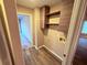 Convenient laundry room with overhead cabinets, shelving, and utility connections at 11447 Vinea Ln, Hampton, GA 30228
