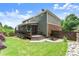 Spacious backyard with a screened porch, beautiful lawn, and wooden fence at 1286 Whisper Cove Dr, Buford, GA 30518