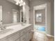 Bathroom with double sinks, a large mirror and a view to the workout room at 1286 Whisper Cove Dr, Buford, GA 30518