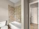 Bathroom featuring a tiled shower and tub with easy access to an adjoining door at 1286 Whisper Cove Dr, Buford, GA 30518
