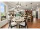 Bright breakfast nook with a modern table set, open to the living room and kitchen at 1286 Whisper Cove Dr, Buford, GA 30518