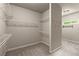 Spacious walk-in closet with multiple levels of shelving for ample storage at 1286 Whisper Cove Dr, Buford, GA 30518