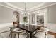 Elegant dining area with stylish chandelier and decor, perfect for formal gatherings at 1286 Whisper Cove Dr, Buford, GA 30518