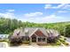 Charming home featuring stone accents, complemented by professionally landscaped yard with colorful plantings and a welcoming front porch at 1286 Whisper Cove Dr, Buford, GA 30518