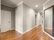 Long hallway with hardwood floors and neutral paint at 1286 Whisper Cove Dr, Buford, GA 30518