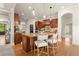 Gourmet kitchen featuring custom wood cabinetry, granite island, and seamless open-concept design at 1286 Whisper Cove Dr, Buford, GA 30518