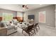 Spacious living room offers lots of light, wood accents, comfortable seating and plush carpeting at 1286 Whisper Cove Dr, Buford, GA 30518