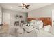 Bright living room includes wood paneling, plush seating, accent chairs and decorative art at 1286 Whisper Cove Dr, Buford, GA 30518