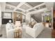 Bright living room with coffered ceilings, stone fireplace, and comfortable seating arrangement at 1286 Whisper Cove Dr, Buford, GA 30518