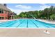 Long shot of community pool with waterslide, lounge chairs, and lane markers at 1286 Whisper Cove Dr, Buford, GA 30518