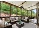 Relaxing screened porch with comfortable seating and views of lush greenery at 1286 Whisper Cove Dr, Buford, GA 30518