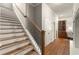Beautiful staircase with hardwood treads, white risers, and decorative iron balusters at 1286 Whisper Cove Dr, Buford, GA 30518