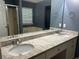 Bathroom featuring dual sinks, granite counters, tub, and window at 159 Parkside Dr, Stockbridge, GA 30281