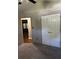 Bedroom featuring carpet, closet, and view to living area at 159 Parkside Dr, Stockbridge, GA 30281