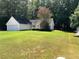 A shot of the home's facade and lawn from a slightly different angle at 159 Parkside Dr, Stockbridge, GA 30281