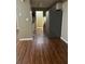 Galley kitchen with stainless steel refrigerator, hardwood floors and neutral walls at 159 Parkside Dr, Stockbridge, GA 30281