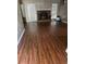 Spacious living room featuring wood-look floors and a brick fireplace at 159 Parkside Dr, Stockbridge, GA 30281