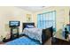 Vibrant bedroom featuring a colorful bedspread, accent rug, and coordinating curtains for a cheerful, lively space at 179 Parkside Dr, Stockbridge, GA 30281