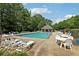 Community pool featuring many chairs, tables, and lounge chairs at 179 Parkside Dr, Stockbridge, GA 30281
