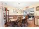 Elegant dining room with a large wooden table, chandelier, and decorative accents at 179 Parkside Dr, Stockbridge, GA 30281