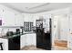 Functional kitchen featuring white cabinets, dark appliances, and durable countertops at 179 Parkside Dr, Stockbridge, GA 30281