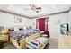 Comfortable main bedroom with a patterned bedspread, ceiling fan, and coordinated decor for a relaxing ambiance at 179 Parkside Dr, Stockbridge, GA 30281