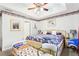 Bright main bedroom featuring a ceiling fan, patterned bedding, and decorative accents for a cozy feel at 179 Parkside Dr, Stockbridge, GA 30281