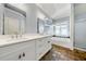 Bright bathroom featuring double sinks, white cabinets, and a soaking tub with a separate glass-enclosed shower at 3278 Shakerley Park, Douglasville, GA 30135