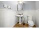 Charming powder room with pedestal sink, wood floors, and white wainscoting at 3278 Shakerley Park, Douglasville, GA 30135