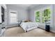 Well-lit bedroom with large windows, neutral carpet, and a closet with built-in shelving for storage at 3278 Shakerley Park, Douglasville, GA 30135
