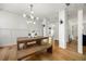 Bright dining area with modern light fixture, wood table, and matching bench seating at 3278 Shakerley Park, Douglasville, GA 30135