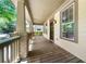 Inviting front porch with wooden flooring, brick pillars, and natural light at 3278 Shakerley Park, Douglasville, GA 30135