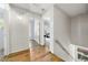 Upstairs hallway with shiplap walls, hardwood floors, and natural light streaming in from a window at the end at 3278 Shakerley Park, Douglasville, GA 30135