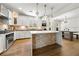 A well-designed kitchen connects to the dining area, featuring a center island and stone backsplash at 3278 Shakerley Park, Douglasville, GA 30135