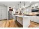 The kitchen boasts a center island, stainless steel appliances, stone backsplash, and bright white cabinets at 3278 Shakerley Park, Douglasville, GA 30135