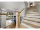 Bright, open living room featuring a staircase, hardwood floors, and a cozy seating area with large windows at 3278 Shakerley Park, Douglasville, GA 30135
