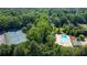 Aerial view showcasing the community's tennis courts, swimming pool, and lush green surroundings at 3627 Pebble Hill Ne Dr, Marietta, GA 30062