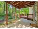 View of a covered back patio with wooden pillars and a view of the yard at 3627 Pebble Hill Ne Dr, Marietta, GA 30062