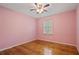 Bedroom with a large window providing natural light and beautiful hardwood floors at 3627 Pebble Hill Ne Dr, Marietta, GA 30062